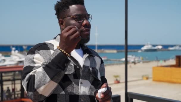 Black Man Putting Ear Earphones Enjoying Music Smartphone Portrait City — Vídeo de Stock