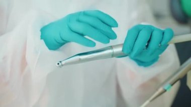 Sağlık kliniğindeki hastalar atanmadan önce dişçi aletlerinin başlığını değiştiriyor, grev eldivenlerindeki ellere yakından bakıyor, diş bakımı ve implantasyonu, diş tedavisindeki modern teknoloji