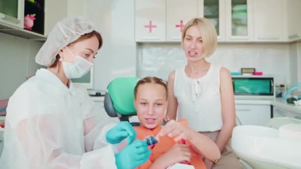 Teen Girl Her Mother Orthodontic Appointment Consultation Orthodontist Dentist Doctor — Stock Video