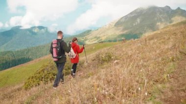 Turistler hafta sonları dağa tırmanıyor, kadın ve erkek yamaçta yürüyor ve temiz hava soluyor, dağlarda ekolojik turizm, seyahat ediyor ve doğayı keşfediyor.