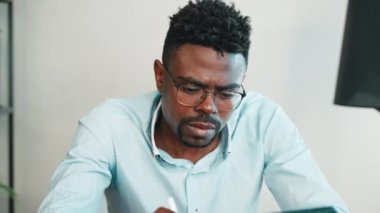 Dijital tabletle çalışan yaratıcı tasarımcı, mobil cihazlı serbest çalışan, Afrikalı Amerikalı adamın portresi, sensör ekranında Stylus tarafından yazılıp çizilen