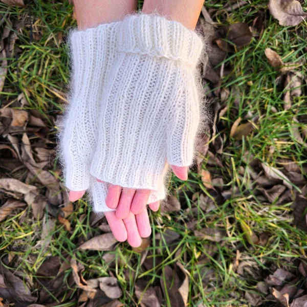 woman in white sweater and gloves on the grass