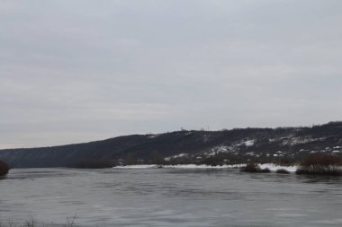 a small boat on the river in the winter