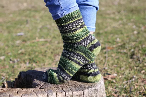 close up of a woman 's feet in green socks
