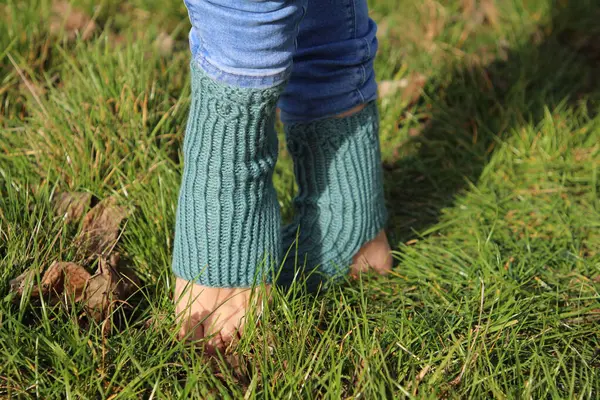 woman wearing green jeans and green grass in forest
