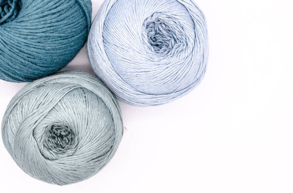 Yarns of wool in blue colors with white background