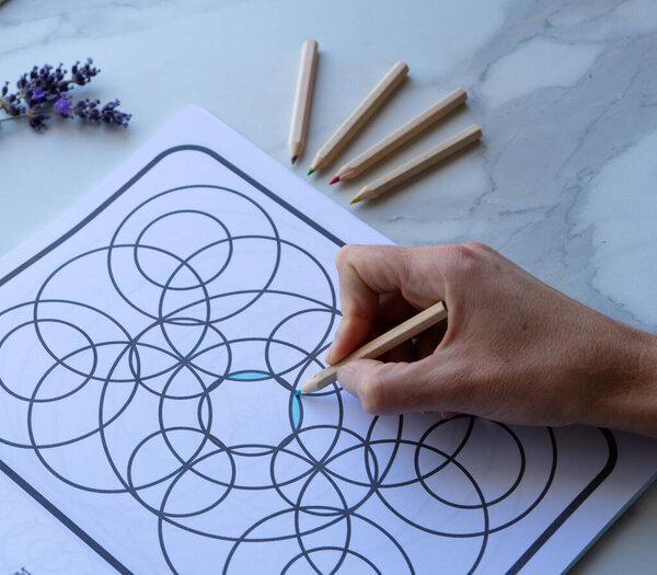 hand drawing an anti-stress coloring book