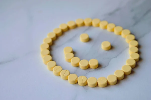 stock image Happy face made with yellow medicine pills