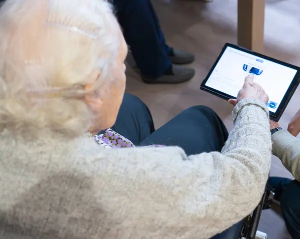 Elderly woman using a tablet