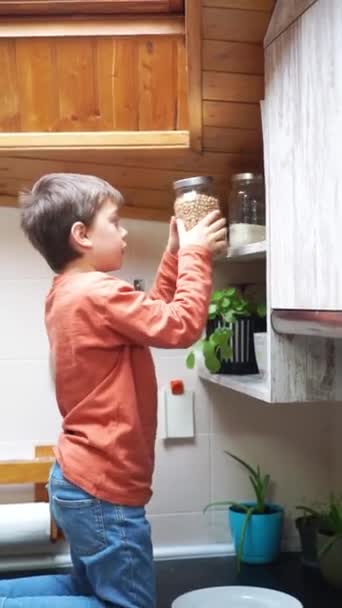 Niño Recogiendo Frasco Vidrio Estante Cocina — Vídeos de Stock