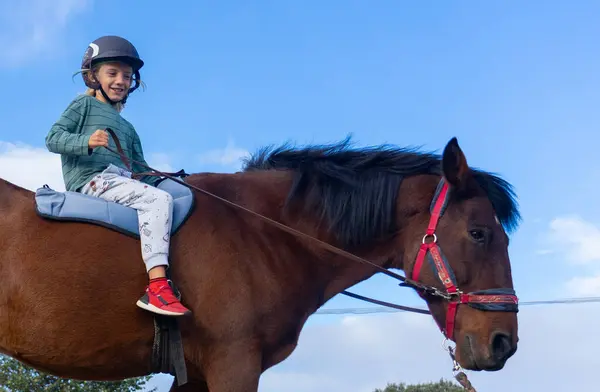stock image Child learning horseback riding on a farm