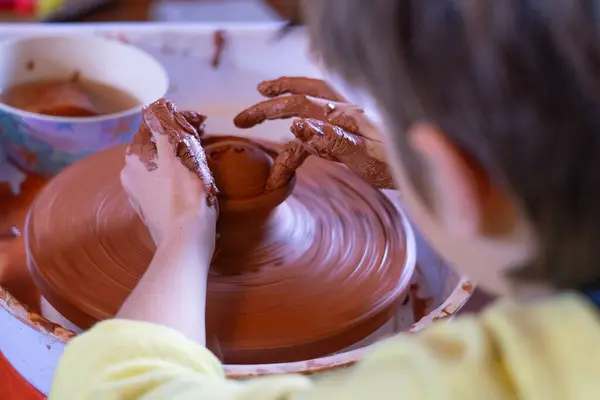 stock image Boy making a clay figure on a potter's wheel