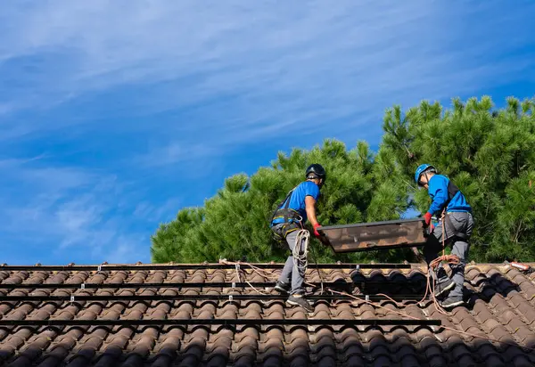 Two men installing solar panels