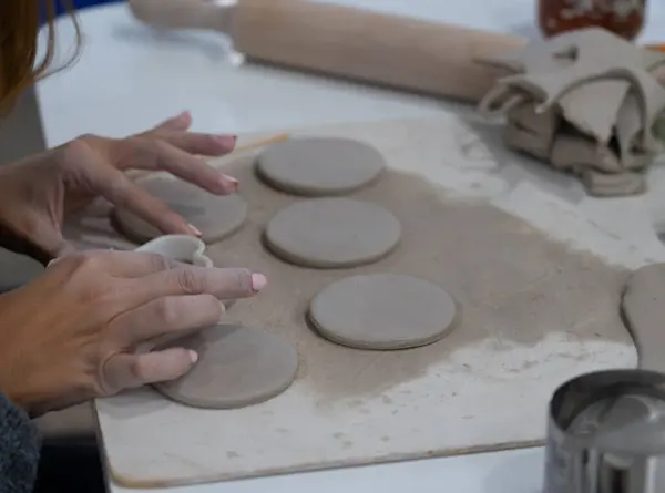 Woman\'s hands making pottery in a workshop