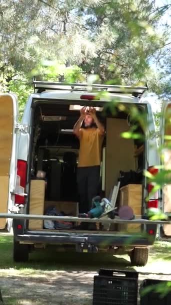 Man Customizing Camper Van Fixing Skylight — Stock Video