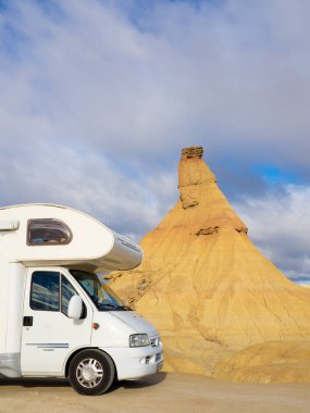 Vertical photo of a motorhome in a desert. Adventure traveling clipart