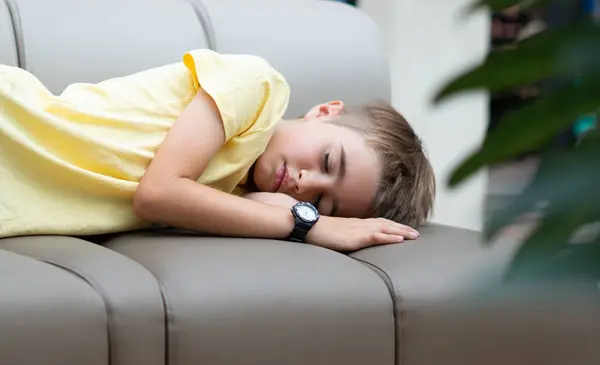 stock image Tired boy sleeping on a sofa