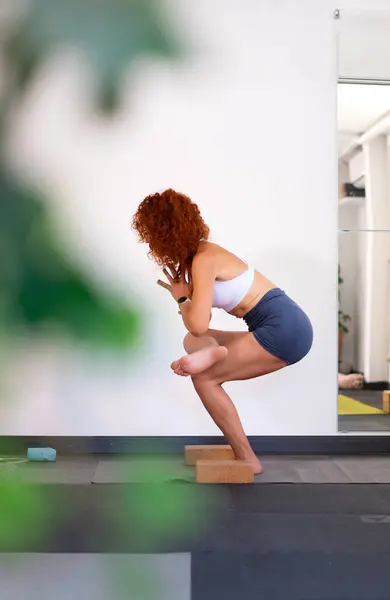 stock image Middle aged Mexican woman yoga instructor doing a yoga pose in her yoga class