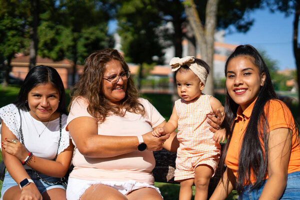 Peruvian family portrait of a mother, grandmother, aunt and baby outdoors
