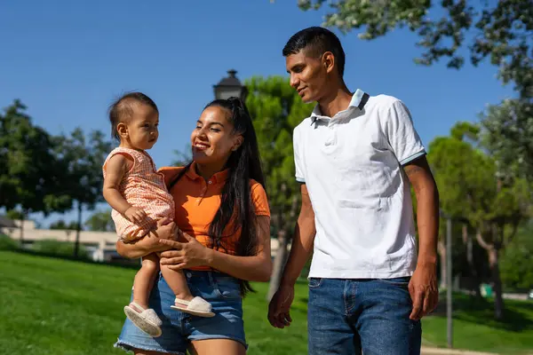 stock image Young Latin family of father, mother and 1 year old baby in a park outdoors