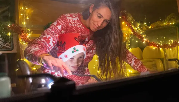 stock image Mother and son cooking in a motorhome dressed in Christmas at Christmas. Ugc