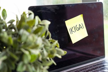 Laptop with a Post it with the word ikigai written on it. Purpose of life. personal growth clipart