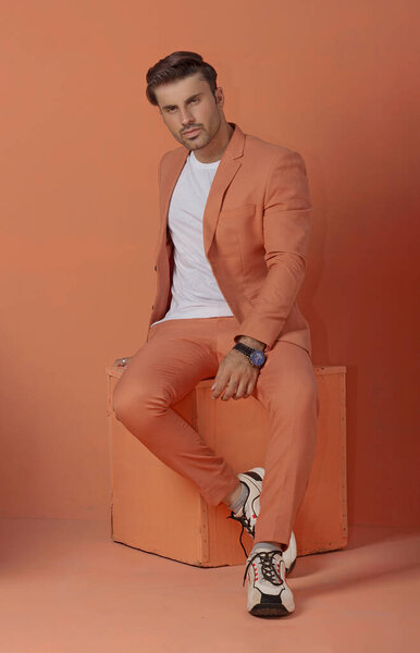 PAKISTANI MALE MODEL POSING IN ORANGE SUIT