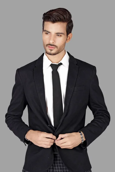 stock image portrait of young handsome business man in suit on black background