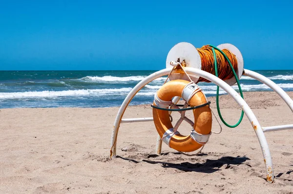 Life ring and rope on a beach in Mar del Plata.