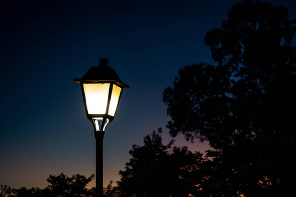A lit street lamp at night