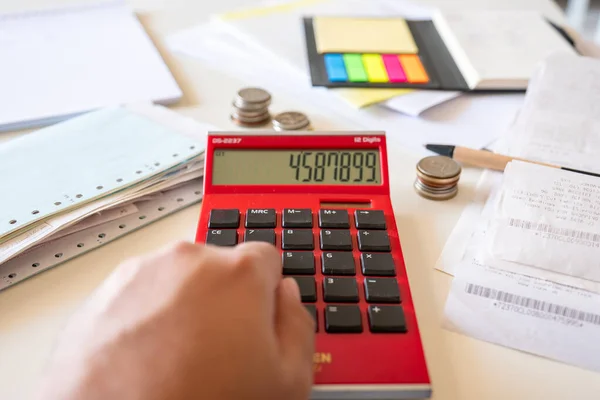Hands of man with financial bills calculating with calculator