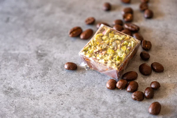 pistachio sweets with coffee beans on grey background