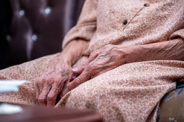 Old woman hands wrinkled feeling lonely without her husband