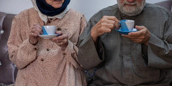 Arabic old couples drinking coffee together