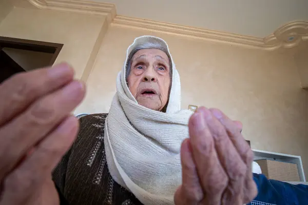Old muslim woman asking allah for help and mercy