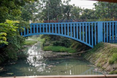 Üzerinde yaya köprüsü olan nehir, geniş açılı gökyüzü arkaplanı.. 