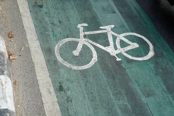 bicycle lanes designated for cyclists, traffic signs painted on the road floor.