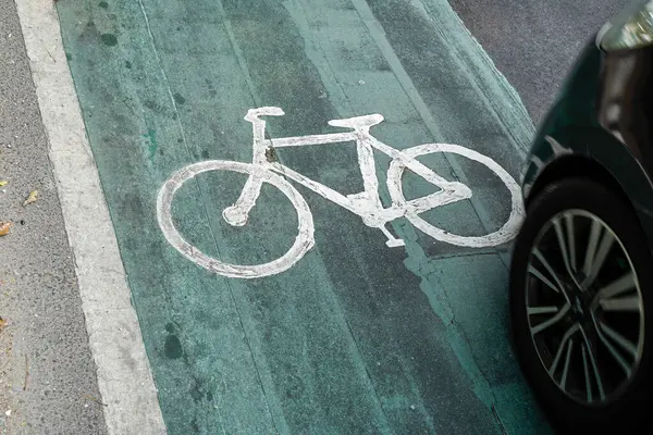 bicycle lanes designated for cyclists, traffic signs painted on the road floor.