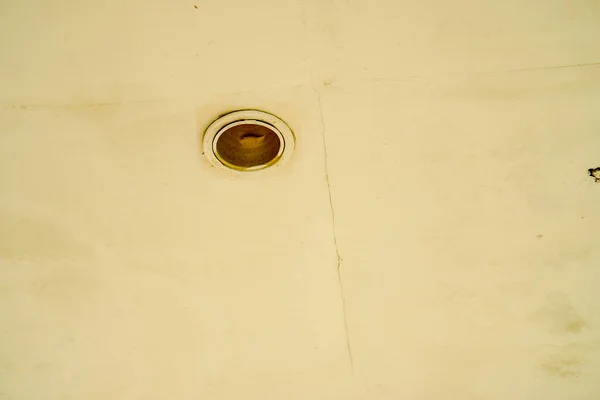 light fixture holes in the ceiling of an old building