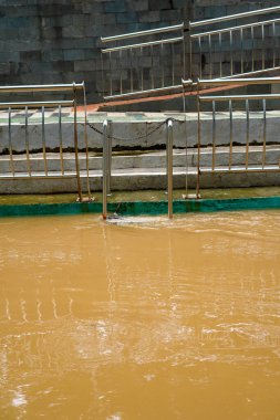 Bir nehri hızlı akan suyla ayıran demir çit..