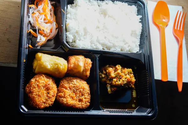 stock image close up of the boxed food on the table.