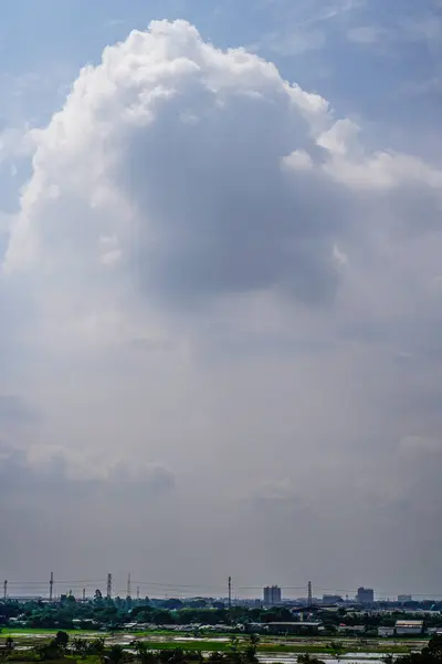 Gökyüzünde bulutlar olan şehrin havadan görünüşü.