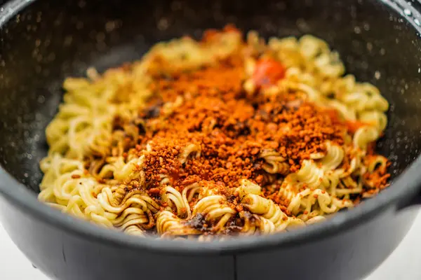 stock image full frame view of fried noodles with spices sprinkled on the surface of the noodles.