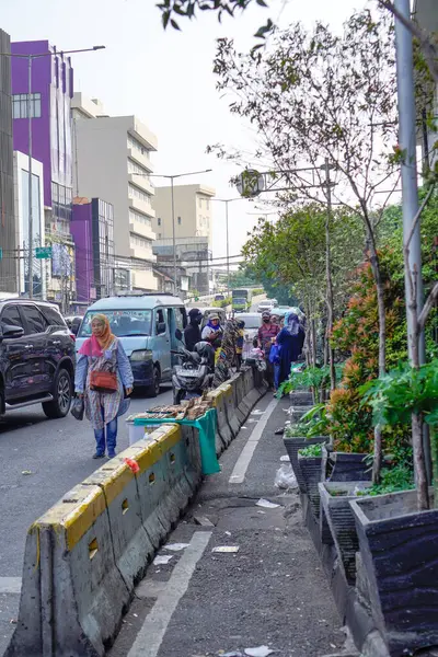 stock image old city of jakarta, july 20, 2024- view of pedestrians and sellers on the side of the road in the old city of Jakarta, 