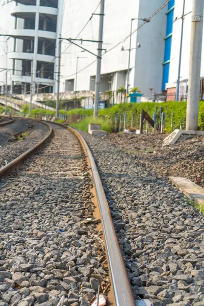 stock image electric train line next to the Ancol urban building, North Jakarta.