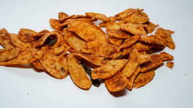 Basreng or fried meatballs, a snack of sliced and fried meatballs sprinkled with spicy spices, isolated on a white background, full view of basreng frem. clipart