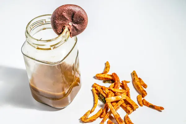 stock image top view of coffee in small jar with spicy snacks isolated on white table. drink and snack concept.