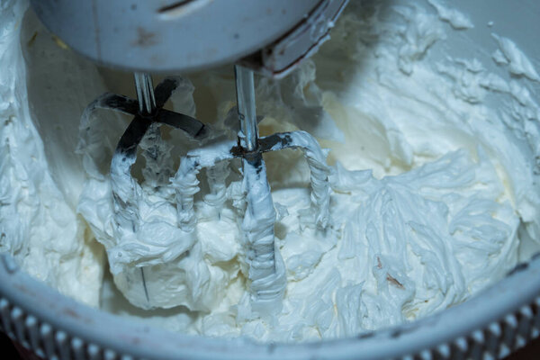 close up view of the dough being mixed using a mixer, making dough with a mixer.