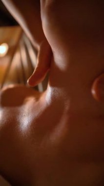 Kozmetik salonundaki usta bir masör genç ve güzel bir kıza masaj yapar. Yakın çekim eller deriyi ve bedeni yağla değiştirir. Mumlarla kaplı karanlık bir ofis.