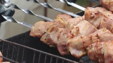 Lezzetli, iştah açıcı biftek eti dışarıda ateşte ve dumanda kızarıyor. Yaz tatilinde arkadaşlarla ızgarada şiş kebap. Kömürlü ızgara ızgara. Yüksek kalite FullHD